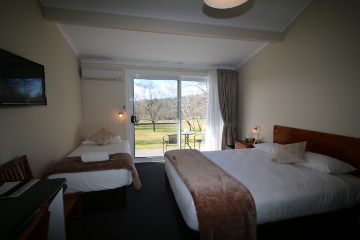 One of the luxurious rooms at Moore Park Inn with a single and Queen Bed, TV and beautiful view of the parklands outside.