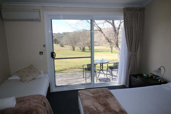 Beautiful view of gardens and sprawling grass and trees from a room in the best accomodation in Armidale
