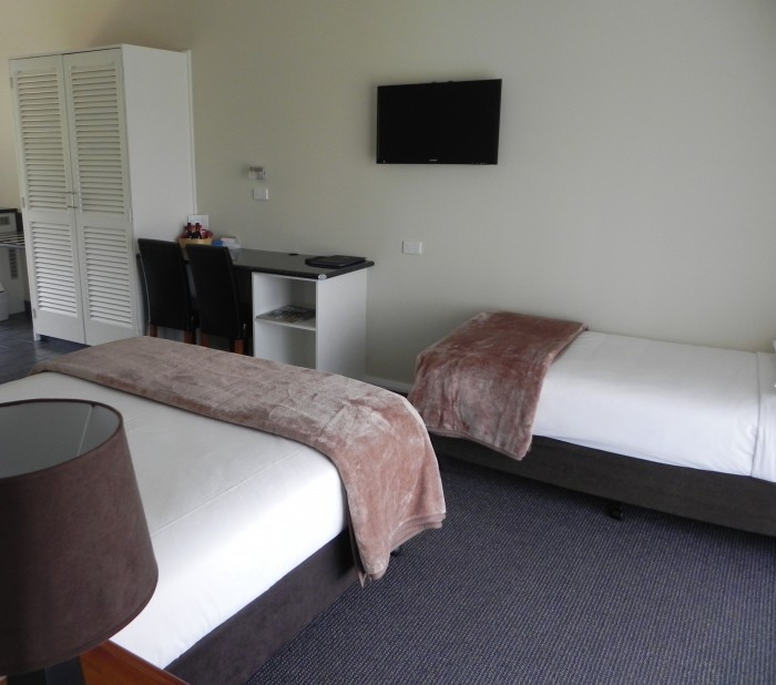 Queen and Single Bed room at Moore Park Inn, with TV, ensuite and kitchenette.